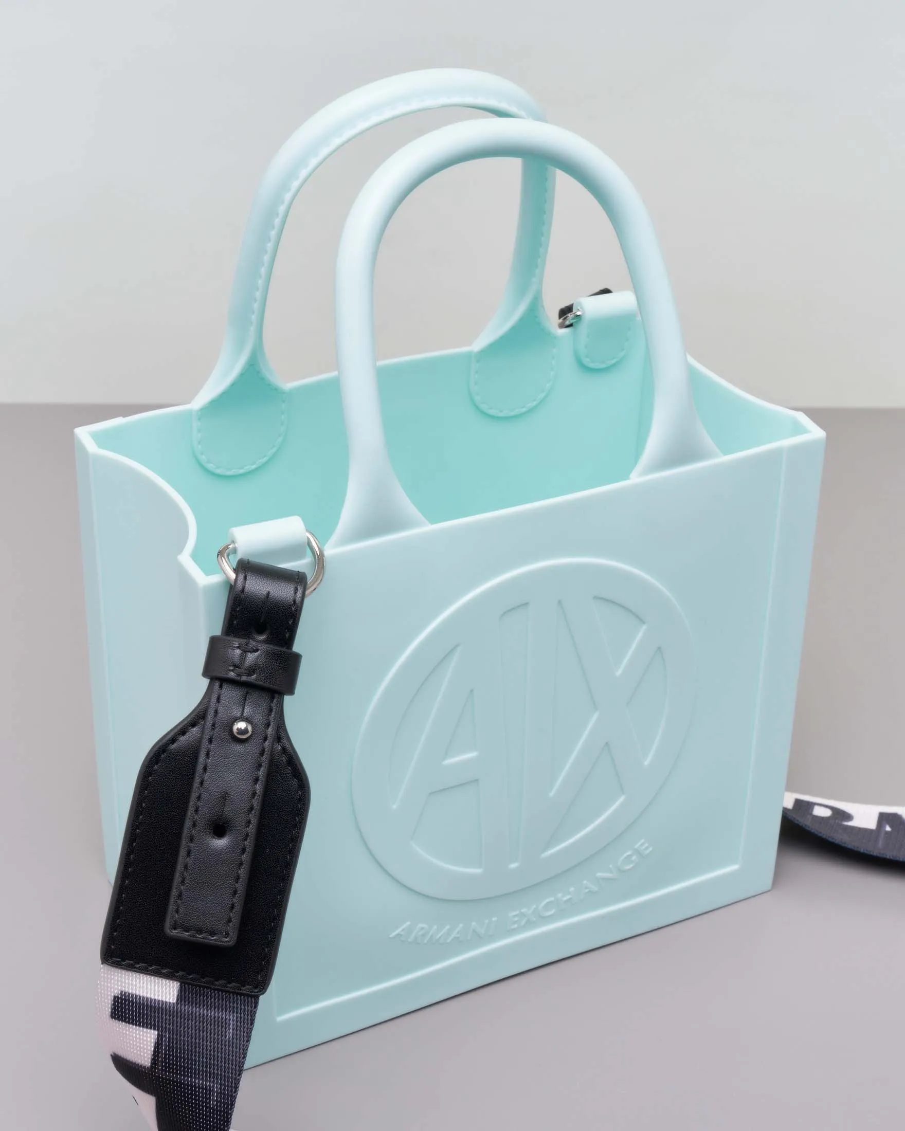 Borsa a mano color acqua misura piccola in gonna con scritta logo a rilievo e tracolla bicolore removibile