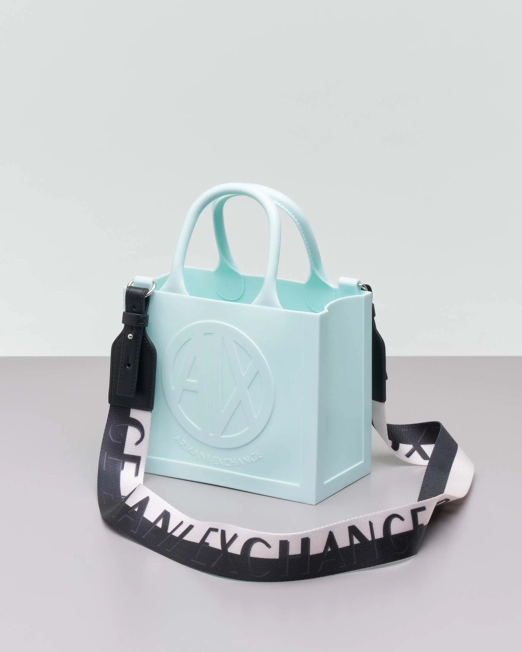 Borsa a mano color acqua misura piccola in gonna con scritta logo a rilievo e tracolla bicolore removibile